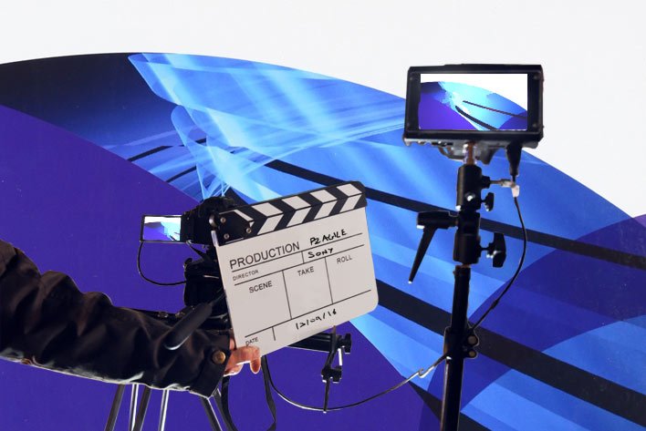 Camera and clapperboard in front of a PRINCE2 Agile background