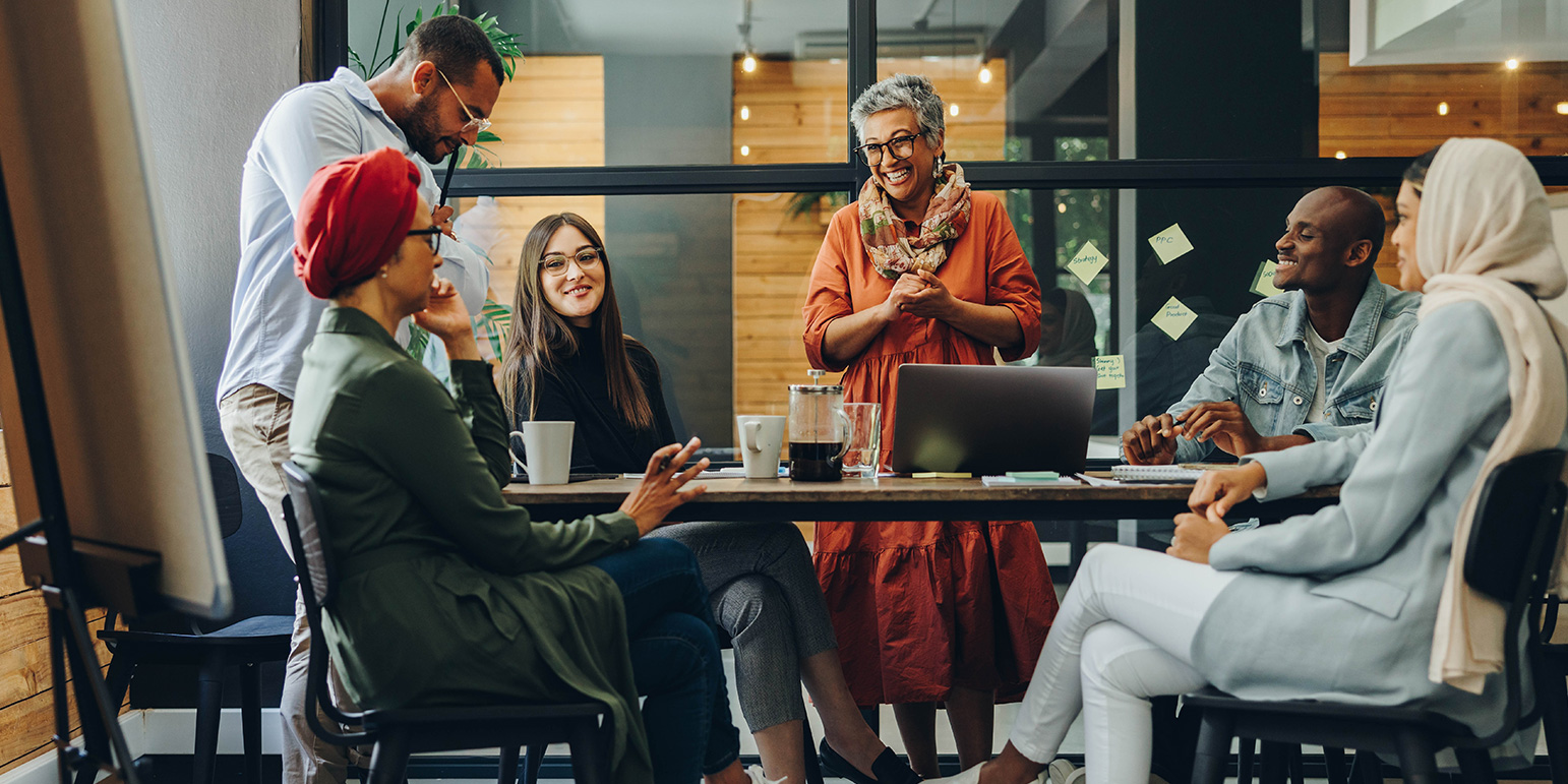 6 people around a meeting desk