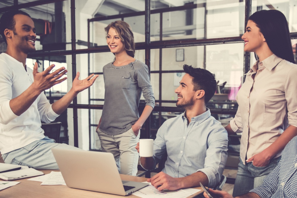 A group of workers listening to another explain something