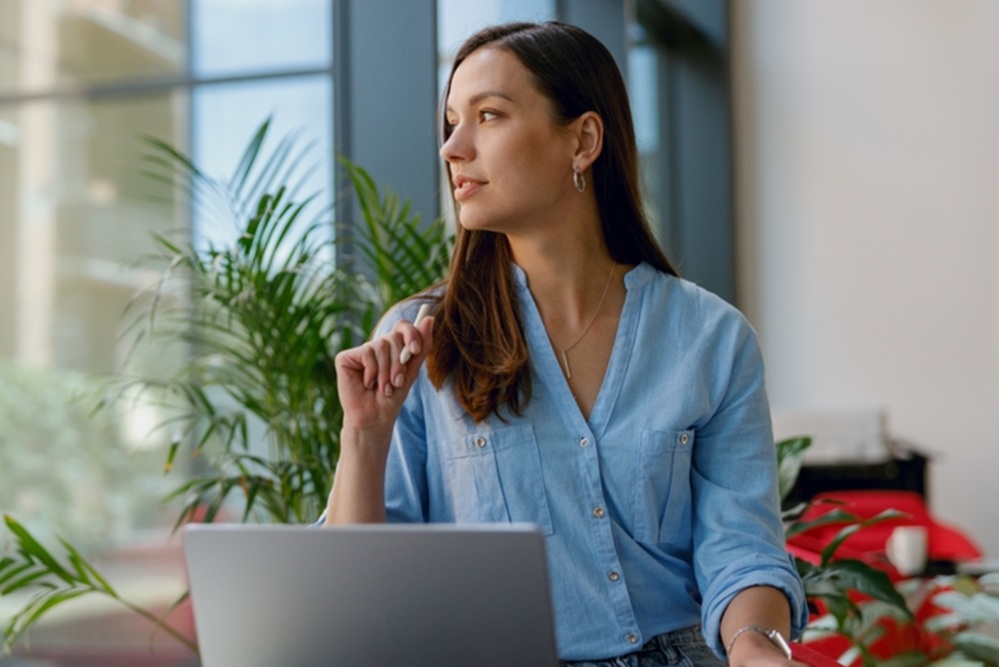 Woman at a desk looking out of the window