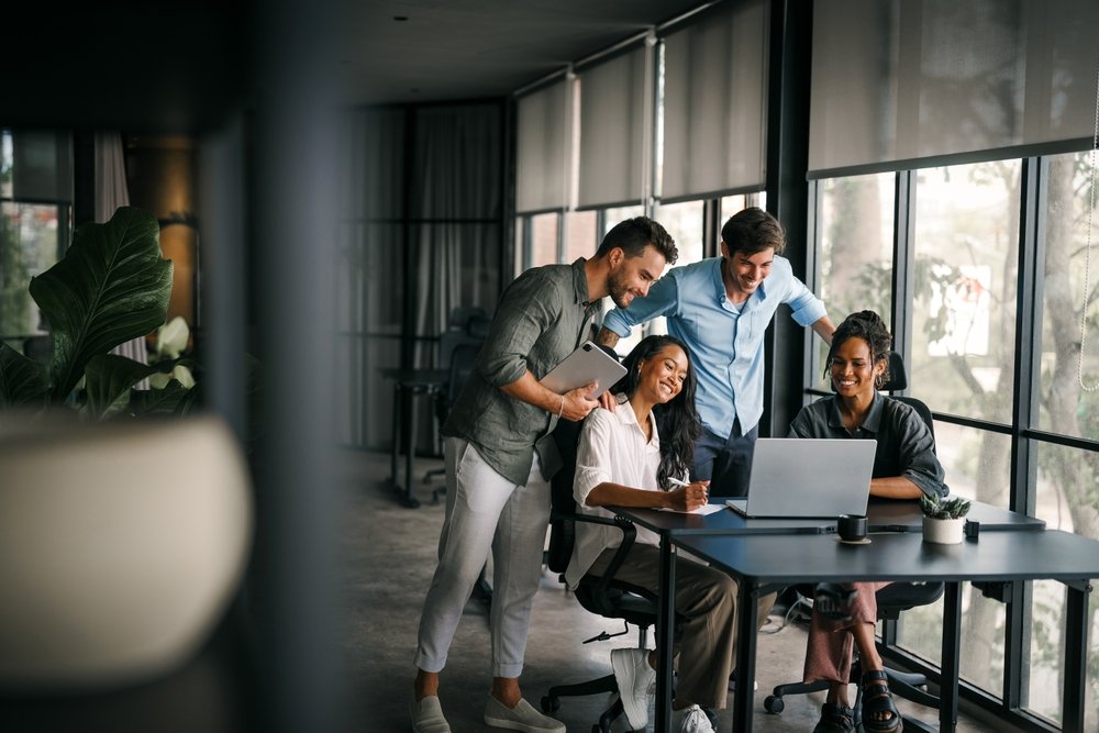 A group of workers round a desk